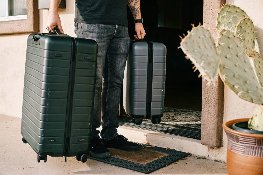 man with bags - moving abroad checklist packing